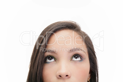 Closeup portrait of a beautiful young woman looking up, isolated