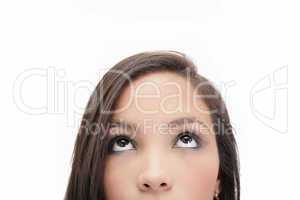 Closeup portrait of a beautiful young woman looking up, isolated