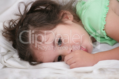 small child holding a finger in his mouth. studio photos. Close-