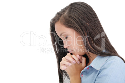 A young woman praying with her hands together on white backgroun