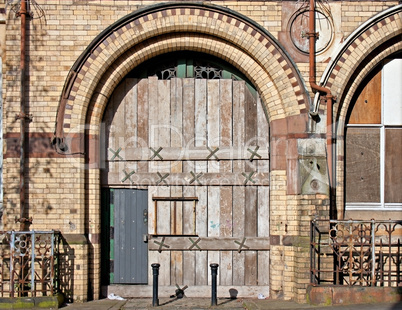 Old boarded up arched doorway
