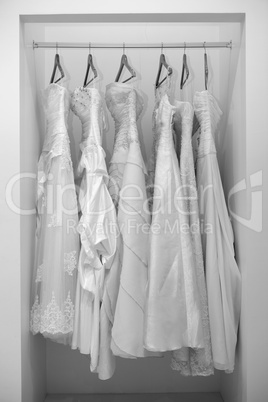 Collection of wedding dresses in the shop in black and white