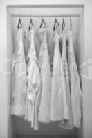 Collection of wedding dresses in the shop in black and white