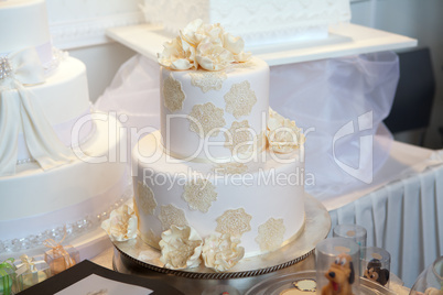 elegant white wedding cake with beige flowers