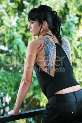 Young woman with painted wings on her back