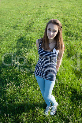 Teenage girl on a green field