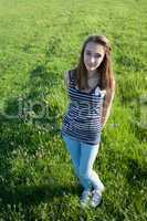 Teenage girl on a green field