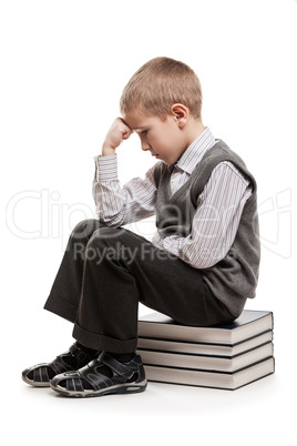 Thinker child sitting on reading books