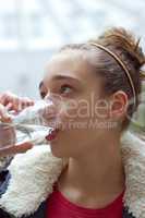 Teenage girl drinking water