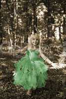 Little girl in fairy costume in the forest