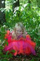 Little girl in fairy costume in the forest