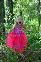 Little girl in princess costume - scream of joy in the forest
