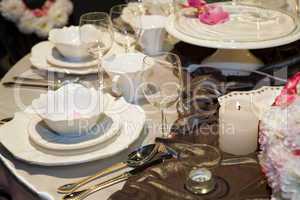 Table setting in beige and brown for elegant dinner