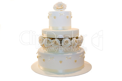 Wedding cake decorated with beige roses, isolated on white
