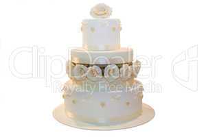 Wedding cake decorated with beige roses, isolated on white