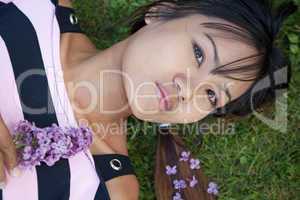 Young Thai woman laying on the grass