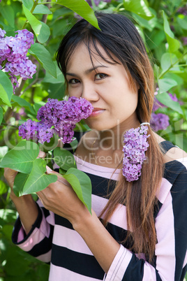 Beautiful Thai woman with lilac flower