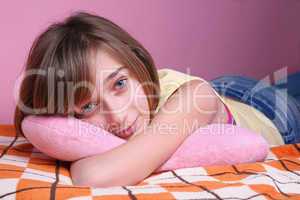 Teenage girl resting on the bed