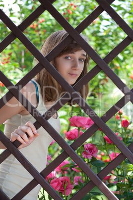 Teenage girl behind a fence