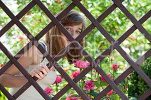 Teenage girl behind a fence