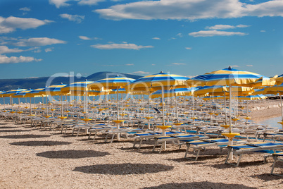 Beach with perfectly parallel lines of parasols