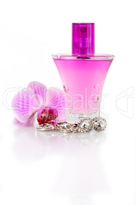 Diamond earrings, perfume and orchid flower