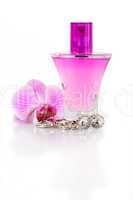 Diamond earrings, perfume and orchid flower