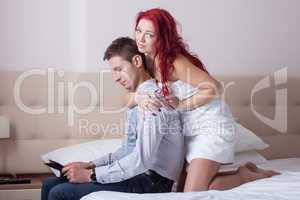 Beautiful redhead woman hugging busy man