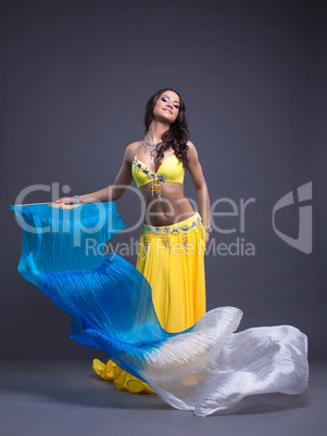 Pretty arabic dancer in yellow costume