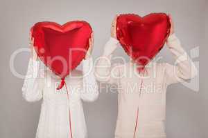 Young couple with balloons in the form of heart