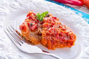 fish in Greek kind with vegetables and tomato sauce