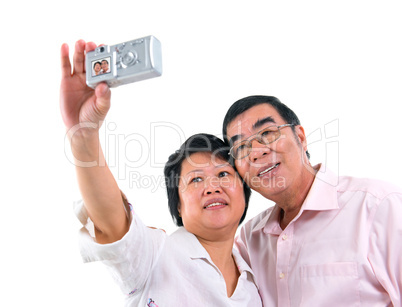 Asian senior couple self photographing
