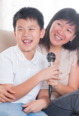 Asian family singing karaoke