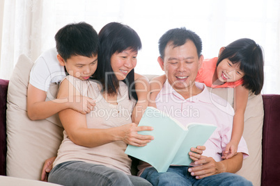 Parents and children reading books at home.