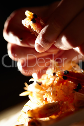 Shrimp in hands. Vertical shot.