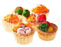 Cupcakes with smiley faces isolated on white.
