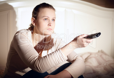 Young woman is watching tv.