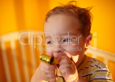 Portrait of the boy playing in playpen.