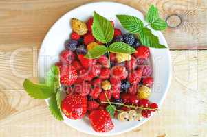 Berries on a plate on a wooden board