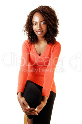 Tall black girl sitting.