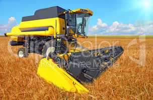 combine harvester on a wheat field with a blue sky