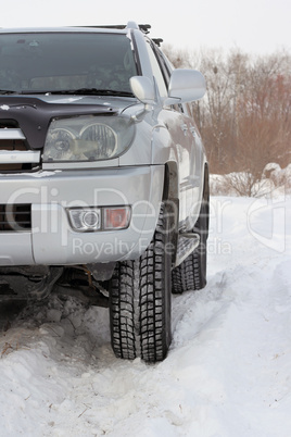 Snowy winter road ahead an unrecognizable car