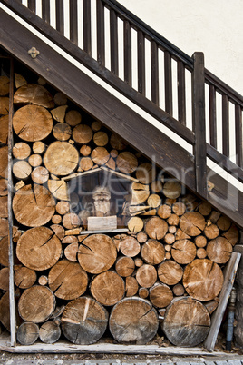 stack of firewood under a ladder