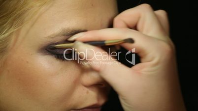 Woman applying eye makeup