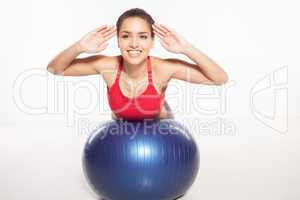 Woman exercising her abs on a pilates ball