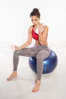 Woman sitting on a pilates ball