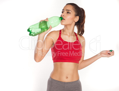 Sporty young woman drinking water