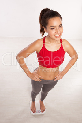 smiling happy woman on a bathroom scale