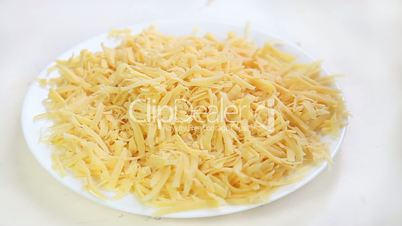 Falling pieces of grated cheese for pizza