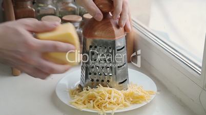 Man grating cheese for pizza